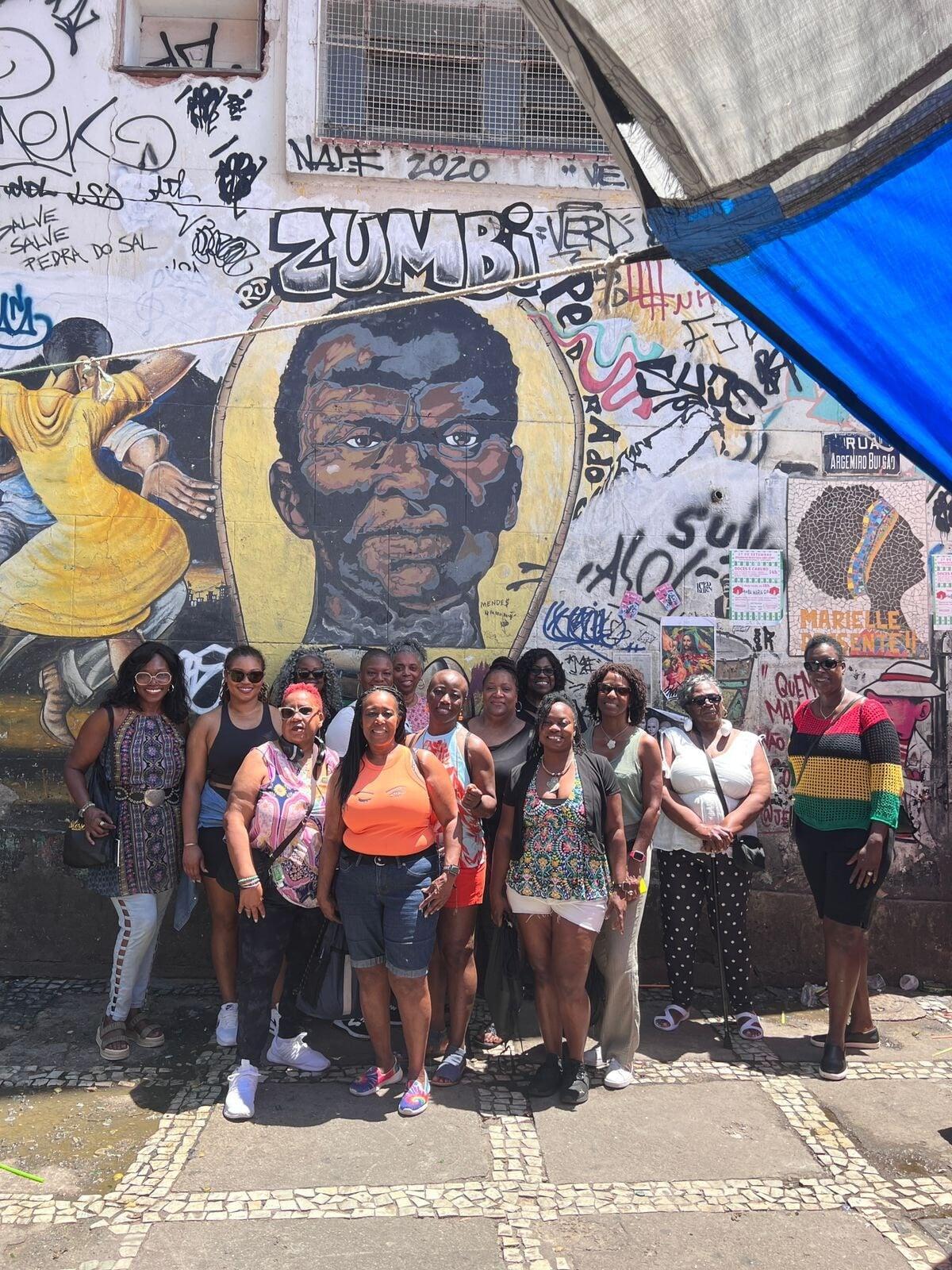 photo of a group of women all wearing gold shirts that say sisters