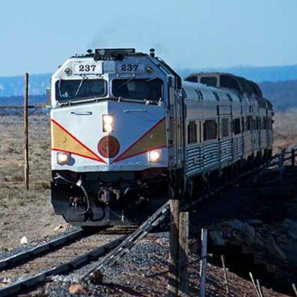 photo of colombian women with fruit on their head walking down the street with stools in their left hand