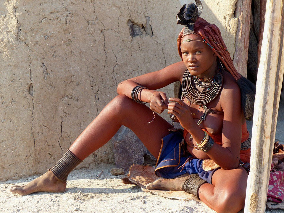 african woman sitting on rocks in namibia
