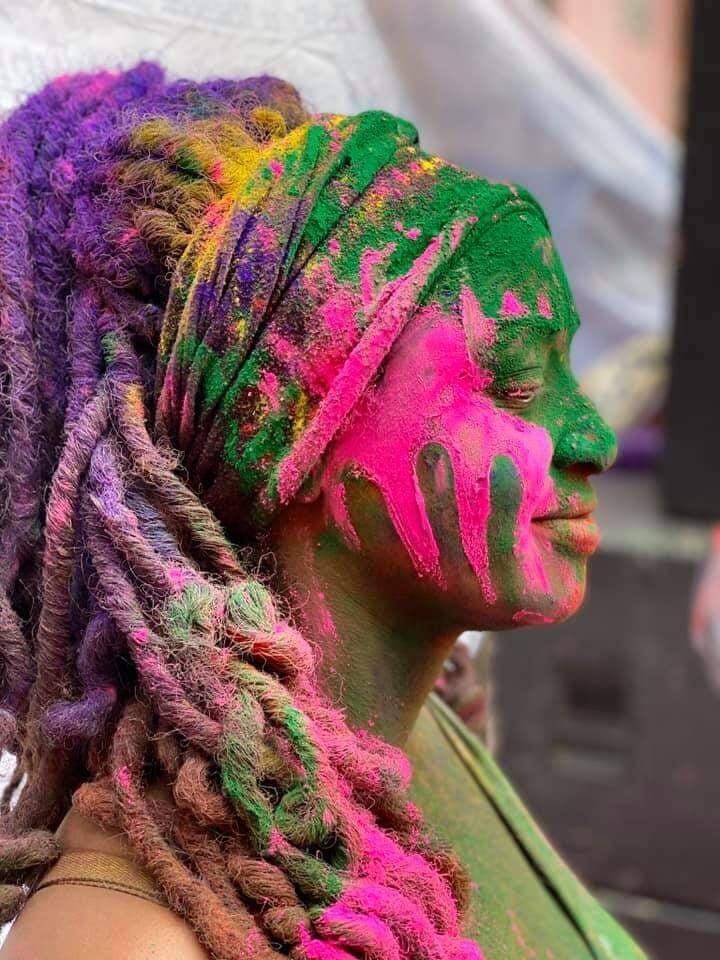 photo of colorful colombian houses with a colombia flag handing over