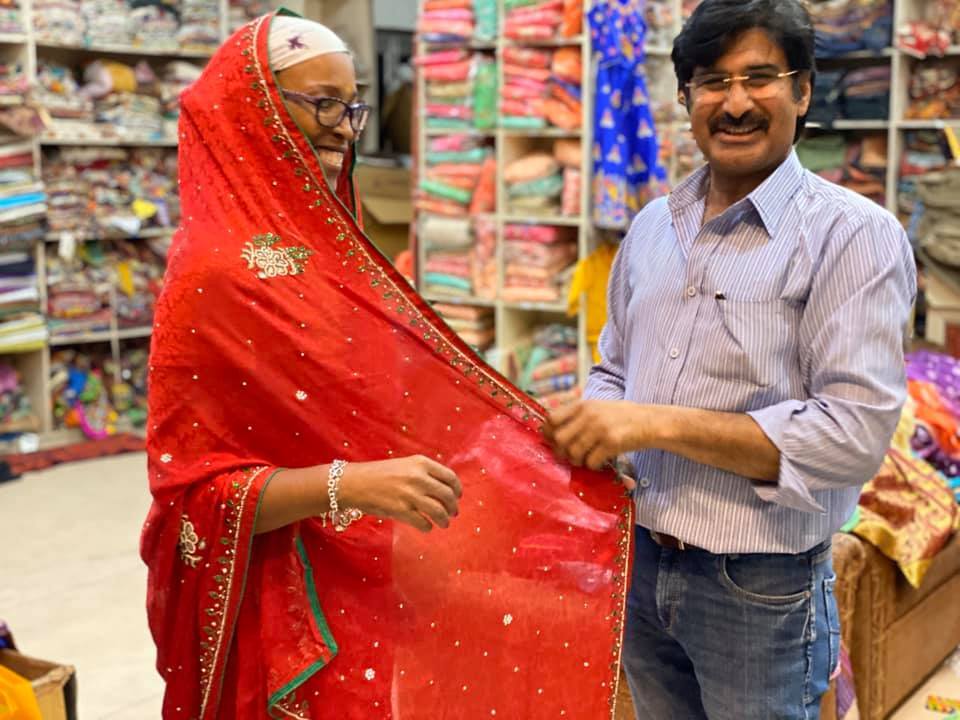 photo of colombian women with fruit on their head walking down the street with stools in their left hand