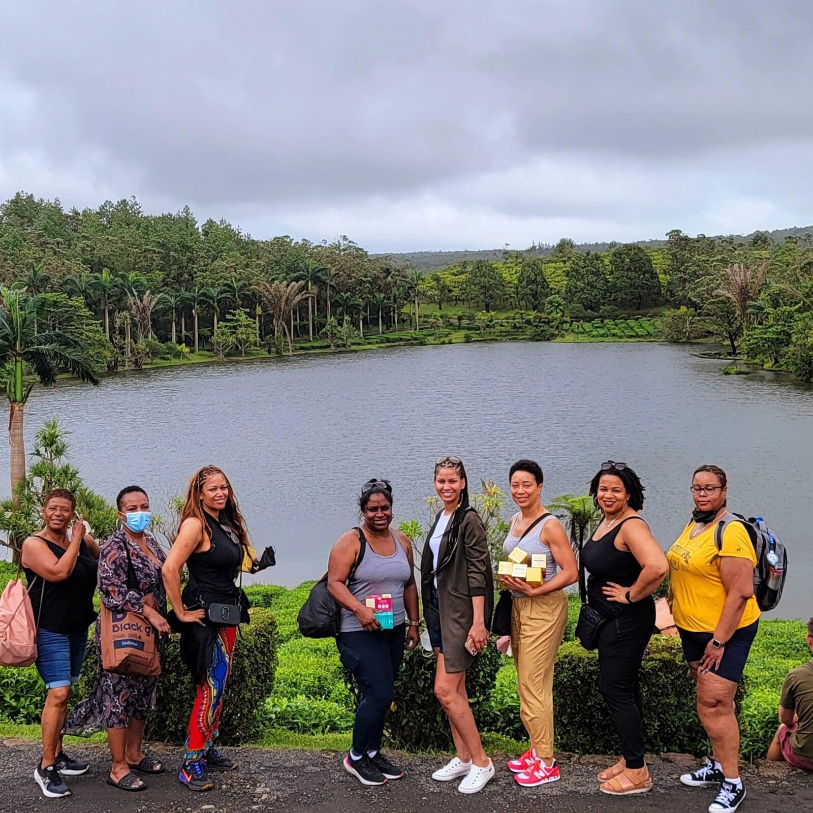 group of women sitting at a lunch table with the view of the ocean in the background