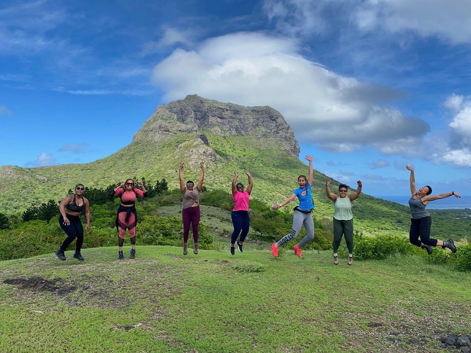 photo of colombian women with fruit standing in front of buildiing