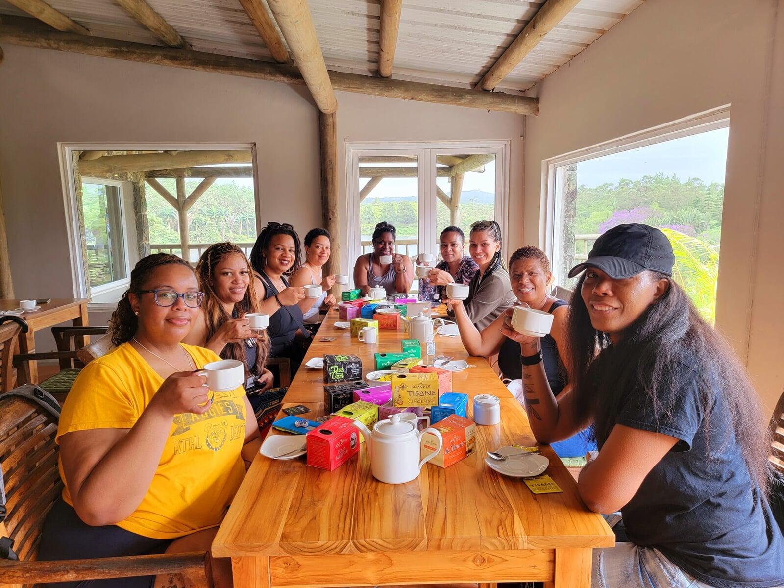 photo of colombian women with fruit on their head walking down the street with stools in their left hand