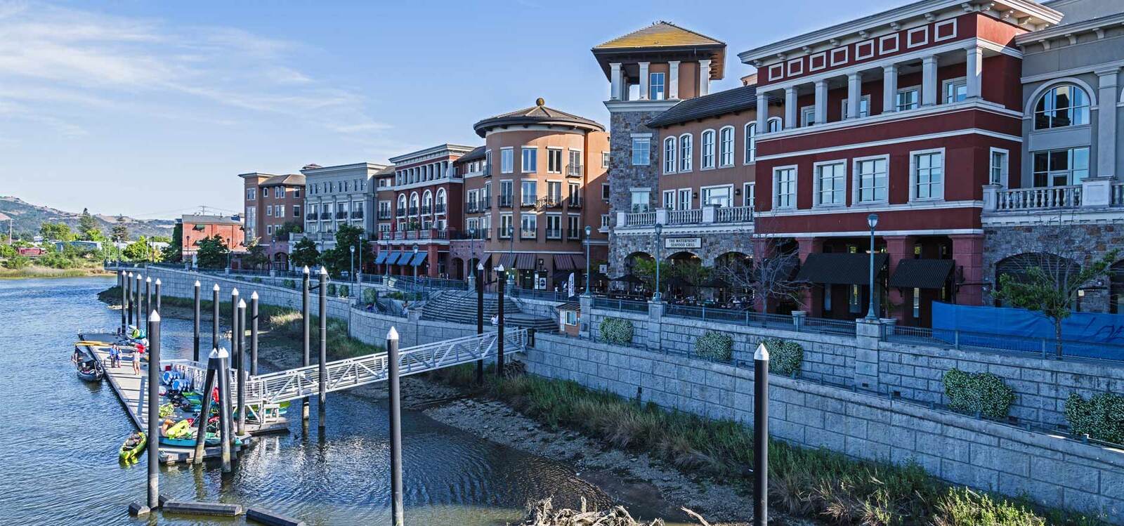 group of women standing in front of a large green door posing for a photo